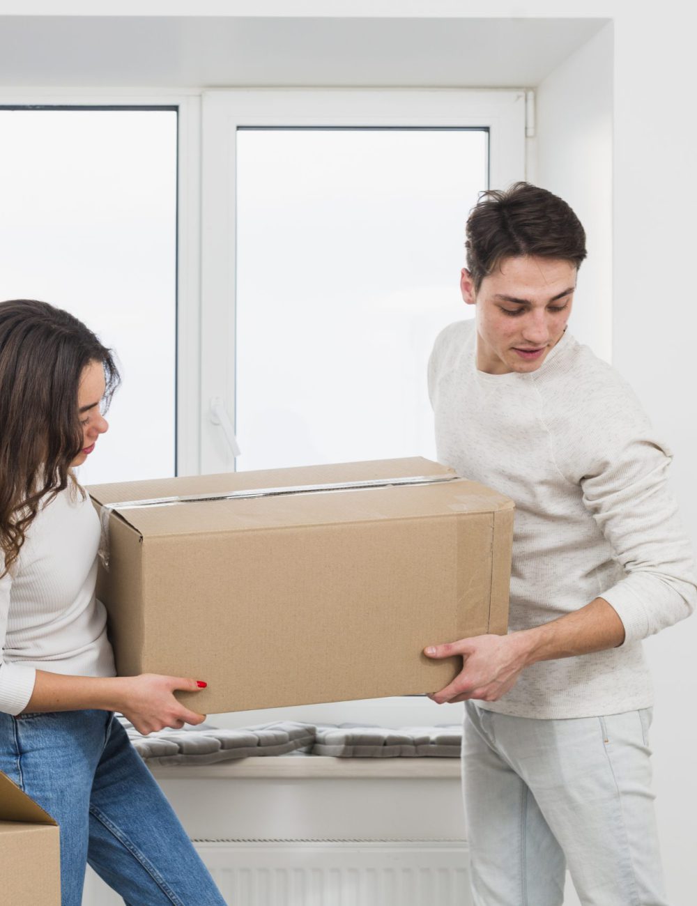 young-couple-carrying-big-cardboard-box-new-home